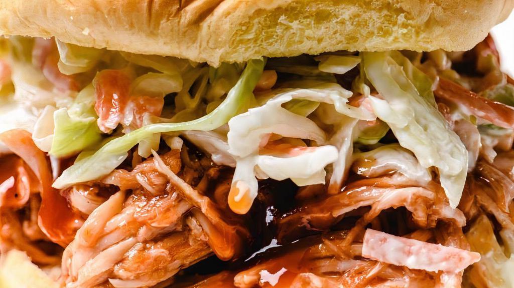 Pork Bbq · A large portion of our delicious Pork BBQ topped with a generous amount of our house made coleslaw all served on a bistro style butter toasted buns.