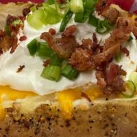 Loaded Baked Potato · Baked potatoes with butter, sour cream, chives & bacon.