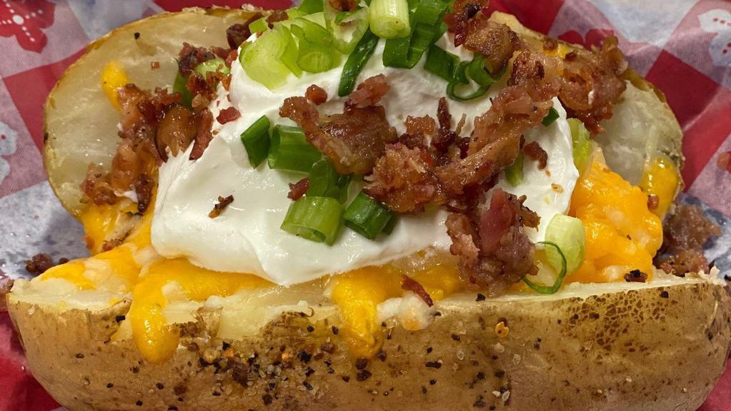 Loaded Baked Potato · Baked potatoes with butter, sour cream, chives & bacon.