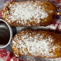 Deep Fried Snickers · Two Snicker candy bars dipped in our funnel cake battered and deep fried, then covered in po...