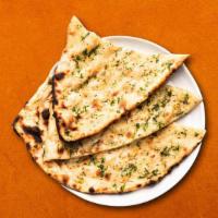 Garlic Naan  · House made hand pulled and leavened dough, loaded with fine chopped garlic and baked to perf...