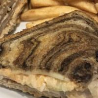 Blake'S Famous Grilled Reuben · With your choice of tender lean slices of corned beef or turkey with sauerkraut, Swiss chees...