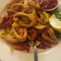 Fried Calamari · Hand battered calamari tossed with banana peppers in a garlic butter and wine sauce. Served ...