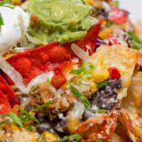 Nachos Grande · a heaping platter of crisp chips topped with salsa chicken or picadillo beef, refried or bla...