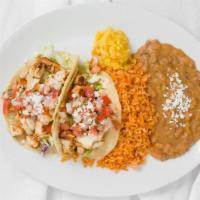 Grilled Chicken Tacos · two homemade, soft flour tortillas filled with grilled chicken, crisp lettuce, pico de gallo...