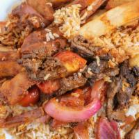 Lomo Saltado · Stir-fried beef sirloin in tomato-soy-vinegar sauce with white rice and steak fries.