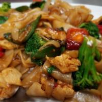 Drunken Noodles · Stir-fried flat rice noodles in chili garlic and homemade soy sauce with jalapeños, red bell...
