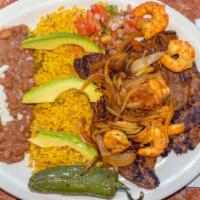 Mar Y Tierra · Grilled steak with shrimp served with rice beans and avocado.