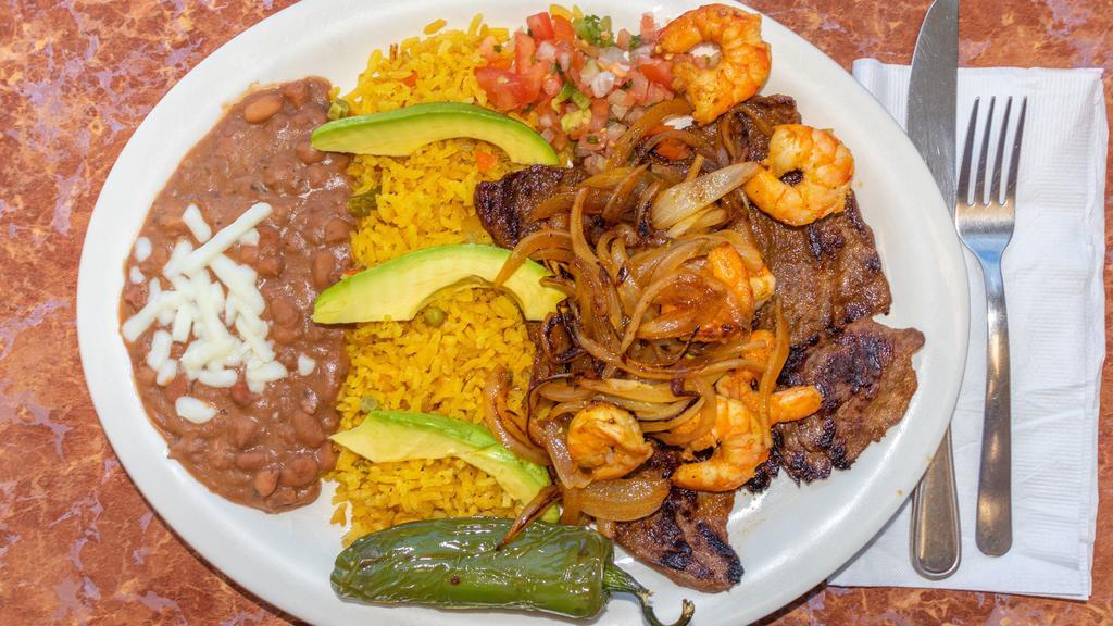 Mar Y Tierra · Grilled steak with shrimp served with rice beans and avocado.