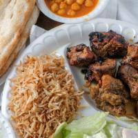 Lamb Kabob · Chunks of tender lamb, marinated in special spices and garlic, broiled on skewers over charc...