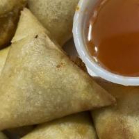 Golden Triangles · Deep fried eggroll shells stuffed with curry seasoned potato and vegetables.