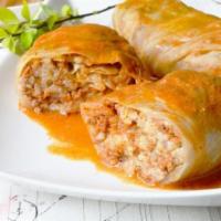 Golubtsy · Cabbage leaves stuffed with ground beef and pork, rice and herbs. Served under a pomidoro/so...