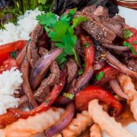 Lomo Saltado · Stir fried beef cooked with onions and tomatoes. Served with white rice and French fries.
