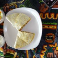 Chicken Quesadillas · Corn tortilla filled with chicken, onions, tomato and cheese and served with guacamole and s...