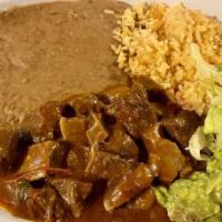 Carne De Puerco · Served with rice, beans/avocado.