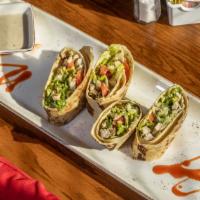 Firecracker Chicken Wraps · Spicy grilled chicken and cheese wrapped in a crispy flour tortilla and served with a cool a...