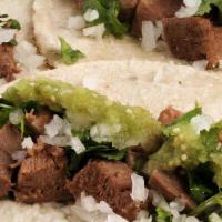 Lengua Tacos /Beef Tongue Tacos · Soft Corn tortilla served with Onions Cilantro, lime and hot sauce on the side.