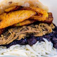 Pabellón · Gluten free. Black beans, sweet plantain, shredded steak topped with queso blanco cheese.