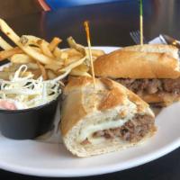 French Dip · Roast beef on a mini baguette and a au jus for dipping.