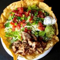 Grilled Chicken Salad · A large deep fried tortilla bowl filled with grilled chicken on a bed of rice & beans, toppe...
