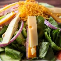 Julienne Salad · Julienne of ham, turkey, American and swiss cheese over crisp greens with tomato wedges and ...