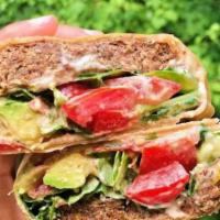 Avocado Tuna · Our homemade avocado tuna, tomatoes, salad sprouts, cucumbers and mixed greens on a whole wh...