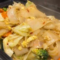 Pad See-Ew (V) · Stir fried flat rice noodles in house special brown sauce with cabbage, carrots, eggs, brocc...