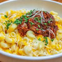 Burnt Ends Mac & Cheese · Cavatappi pasta topped with creamy cheese sauce.