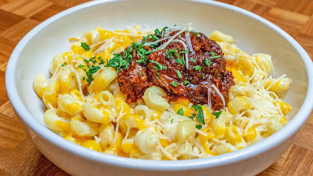 Burnt Ends Mac & Cheese · Cavatappi pasta topped with creamy cheese sauce.