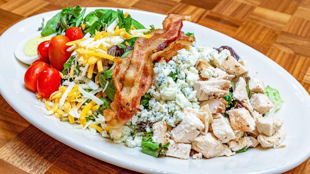 Cobb Salad · Chicken, bacon, tomatoes, boiled eggs, avocado, shredded cheese, crumbled bleu cheese.