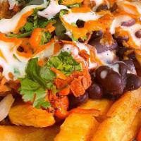 Loaded Fries · Crispy fries covered in our queso (dairy and nut free), beans, plant based meat of your choi...