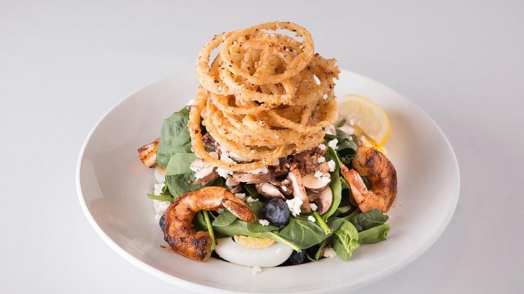 Blackened Shrimp Spinach Salad · Blackened shrimp over fresh spinach, bacon, sliced mushrooms, boiled eggs, . feta cheese, crispy onion strings and fresh blueberries, with warm bacon-brown sugar dressing.