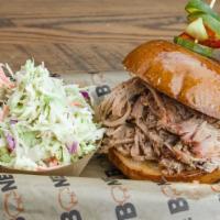 Pulled Pork Sandwich · Hand pulled and tossed in our Carolina style BBQ sauce. Served on toasted bun with house mad...