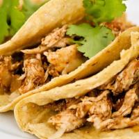 Taco De Pollo · Chicken fajita, with grilled onions topped with cilantro with a slice of lime.