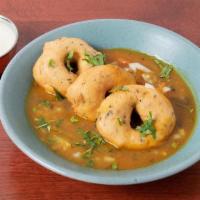 Sambhar Vada · (Vegan) South Indian deep fried lentil doughnuts served immersed in sambhar, onion & crisps.