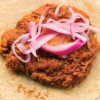 Cochinita Pibil · Shredded pork in a sweet achiote chile topped with a spicy habanero salsa and pickled red on...