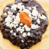 Frijoles Con Queso · Black beans topped with queso fresco and chipotle chile.