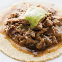 Steak Picado · Flank steak braised with green bell peppers and bacon. Topped with salsa verde.