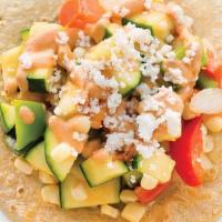 Calabacitas · Squash tomatoes corn bell peppers and onion topped with chipotle crema and queso fresco.