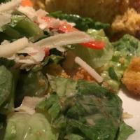 Caesar Salad · Romaine lettuce, red peppers, and cornbread croutons, tossed in Caesar dressing. Garnished w...