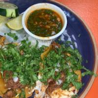 Birria Tacos · One soft tortilla taco with birria served with cilantro onions lemon and cucumber.