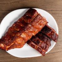 Baby Back Pork Ribs · Our Baby Back Ribs are rubbed in our flavorful dry rub and  slow smoked until they fall off ...