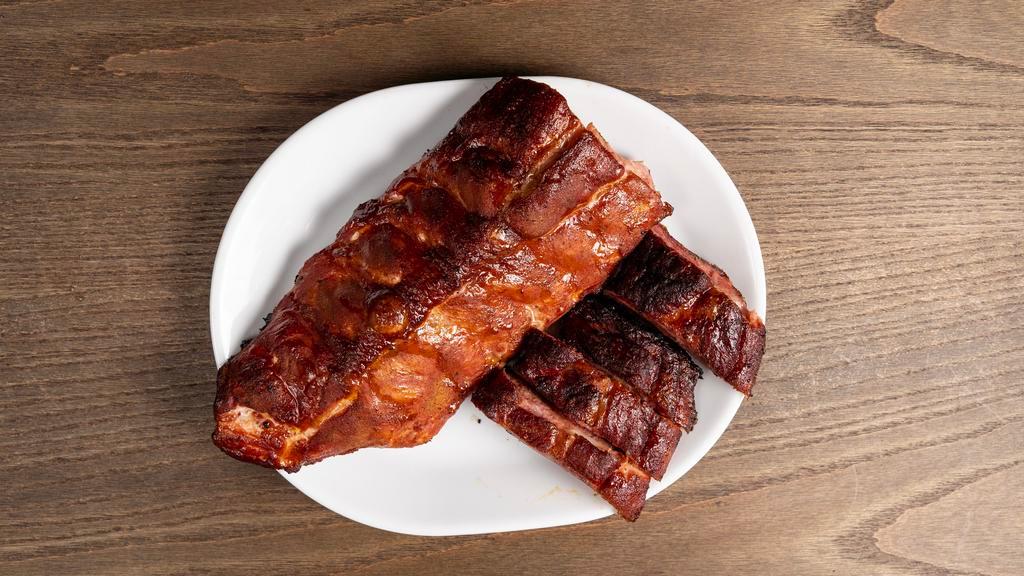 Baby Back Pork Ribs · Our Baby Back Ribs are rubbed in our flavorful dry rub and  slow smoked until they fall off the bone.