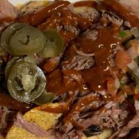 Nachos · A generous one pound of Nacho chips with homemade cheddar sauce, brisket OR pulled pork, pic...