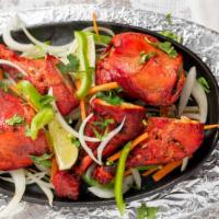 Tandoori Chicken · Chicken marinated in yogurt & fresh mild spices and roasted over charcoal in the tandoor.