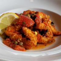 Montego Bay Calamari · FLASH FRIED TENDER STRIPS OF CALAMARI 
SAUTÉED IN HERB BUTTER WITH TOMATOES, 
CAPERS, SCALLI...