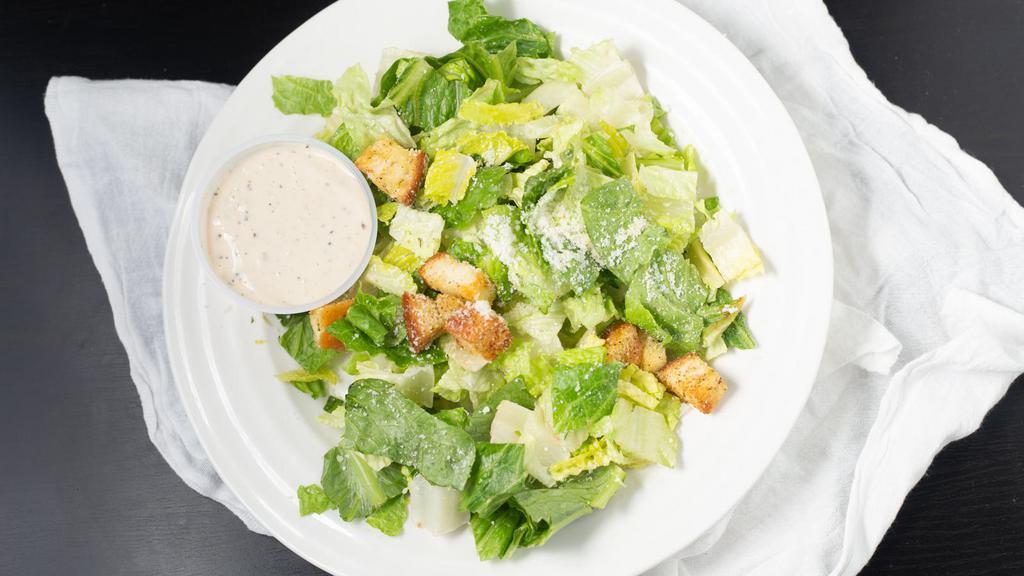 Caesar Salad · Crisp hearts of romaine lettuce with our creamy caesar dressing, grated Parmesan, and croutons.