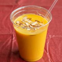 Mango Lassi · Thick Yogurt Drink made with Real Mango Pulp  topped with dried fruits