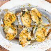 Oyster Justice · Signature dish. Baked oysters topped with shrimp, crab meat, spinach & imperial sauce.