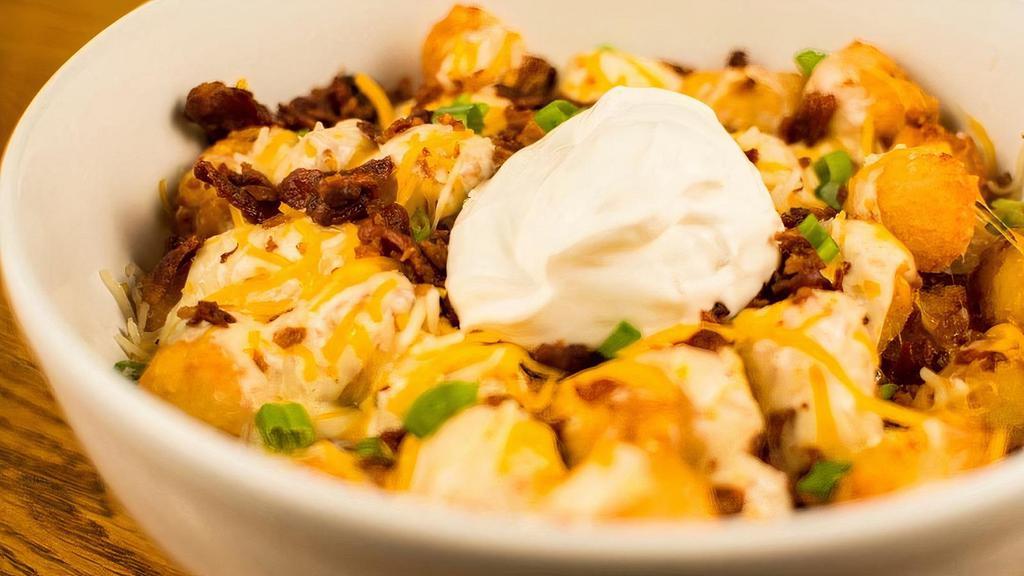 Loaded Spuds · Tater tots, pepper jack queso, applewood smoked bacon, sour cream and green onion